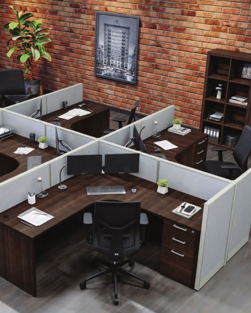 Open office with low-panel L-shaped workstations behind 42-inch gray fabric walls, sightlines open across the room